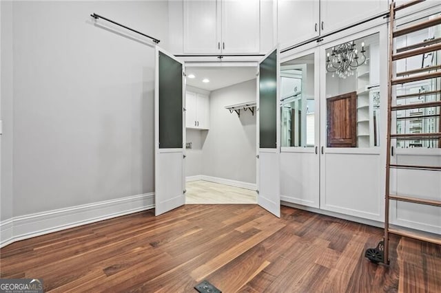 1101 N Flat Rock Rd, Douglasville, GA 30134 - walk in closet featuring an inviting chandelier and dark wood finished floors