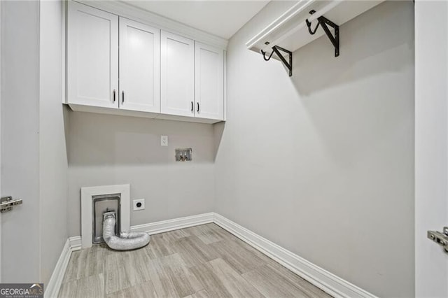 1101 N Flat Rock Rd, Douglasville, GA 30134 - laundry room with baseboards, hookup for a washing machine, light wood-type flooring, electric dryer hookup, and cabinet space