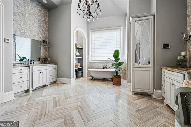 1101 N Flat Rock Rd, Douglasville, GA 30134 - bathroom featuring vanity, baseboards, a freestanding bath, and a notable chandelier