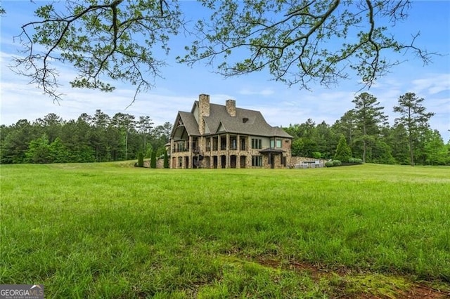 1101 N Flat Rock Rd, Douglasville, GA 30134 - back of house featuring a chimney and a yard