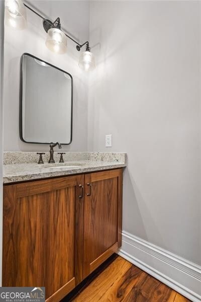 1101 N Flat Rock Rd, Douglasville, GA 30134 - bathroom with vanity, baseboards, and wood finished floors