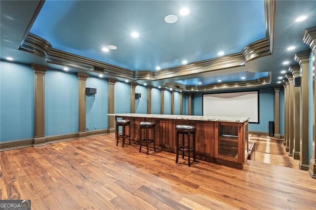 1101 N Flat Rock Rd, Douglasville, GA 30134 - bar featuring ornamental molding, decorative columns, wood finished floors, and a dry bar