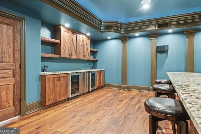 1101 N Flat Rock Rd, Douglasville, GA 30134 - bar with indoor wet bar, ornate columns, light wood finished floors, and wine cooler