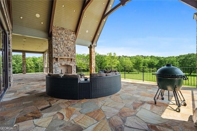 1101 N Flat Rock Rd, Douglasville, GA 30134 - view of patio / terrace with a view of trees, an outdoor living space with a fireplace, fence, and area for grilling