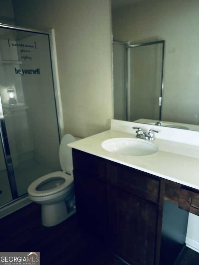 107 Highwood Ln, East Point, GA 30344 - bathroom with vanity, toilet, wood finished floors, and a stall shower