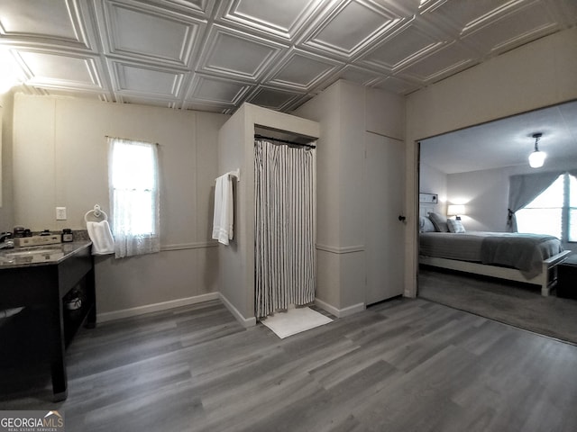 328 Kelly Creek Rd, Waco, GA 30182 - bedroom with wood finished floors, baseboards, an ornate ceiling, and a sink