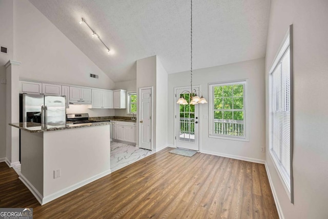 5135 Gable Ridge Way, Sugar Hill, GA 30518 - kitchen with white cabinets, appliances with stainless steel finishes, a textured ceiling, under cabinet range hood, and visible vents