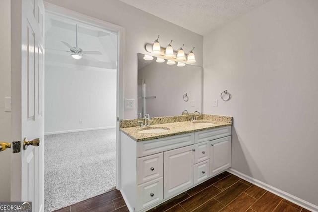 5135 Gable Ridge Way, Sugar Hill, GA 30518 - bathroom with double vanity, a sink, baseboards, and wood finished floors