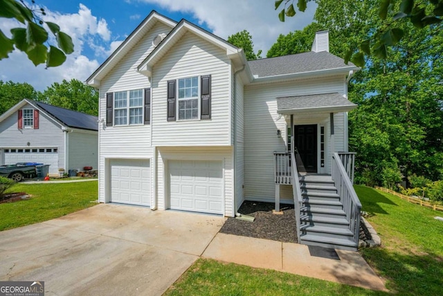 5135 Gable Ridge Way, Sugar Hill, GA 30518 - split level home with concrete driveway, a chimney, a front yard, and a garage