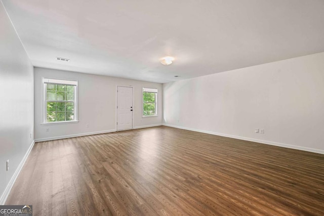 5135 Gable Ridge Way, Sugar Hill, GA 30518 - unfurnished living room featuring baseboards, dark wood-style flooring, and visible vents