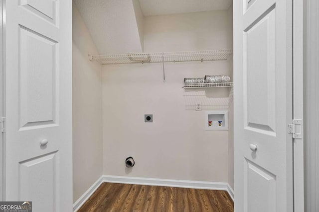 clothes washing area featuring laundry area, dark wood-style flooring, baseboards, hookup for a washing machine, and hookup for an electric dryer