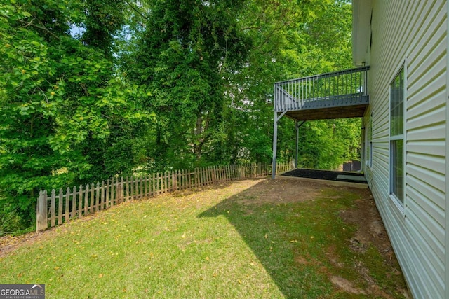 view of yard with fence and a wooden deck