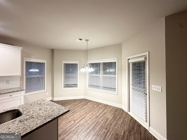 51 Donegal Ct, Dallas, GA 30132 - unfurnished dining area with an inviting chandelier, dark wood-style flooring, baseboards, and visible vents