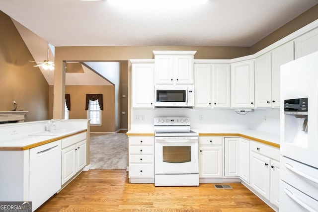 1008 Walnut Creek Dr, Woodstock, GA 30188 - kitchen featuring visible vents, white appliances, light countertops, white cabinetry, and a sink