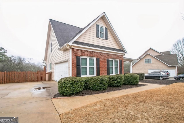 1008 Walnut Creek Dr, Woodstock, GA 30188 - view of side of property featuring fence, a shingled roof, brick siding, a garage, and concrete driveway