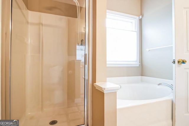 1008 Walnut Creek Dr, Woodstock, GA 30188 - bathroom with a garden tub, a stall shower, and a wealth of natural light