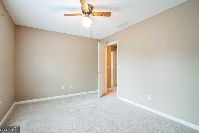 1008 Walnut Creek Dr, Woodstock, GA 30188 - spare room with baseboards, ceiling fan, visible vents, and light colored carpet