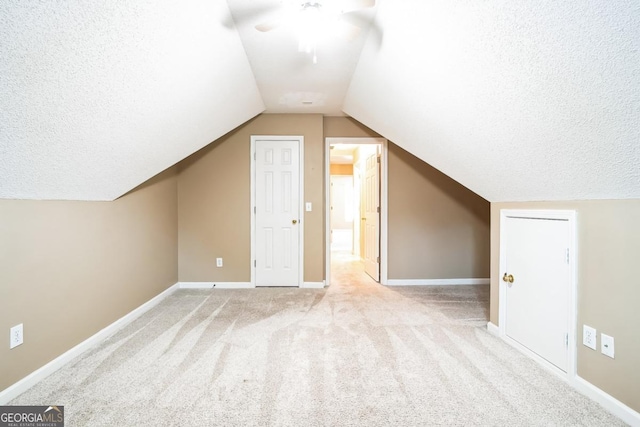 1008 Walnut Creek Dr, Woodstock, GA 30188 - additional living space featuring baseboards, a textured ceiling, a ceiling fan, carpet, and vaulted ceiling