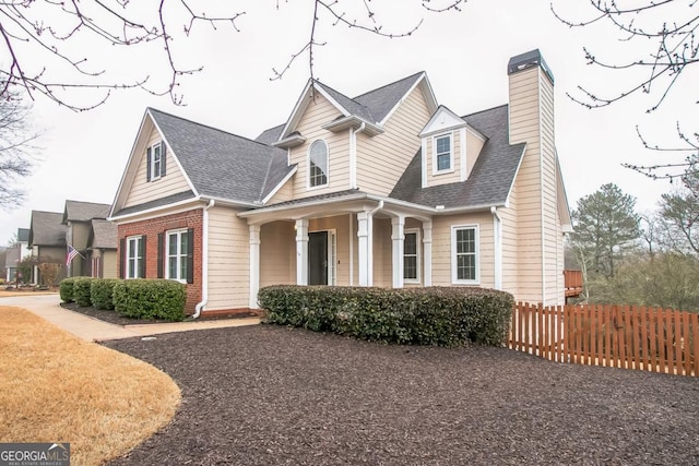 1008 Walnut Creek Dr, Woodstock, GA 30188 - cape cod-style house featuring a shingled roof, fence, and a chimney