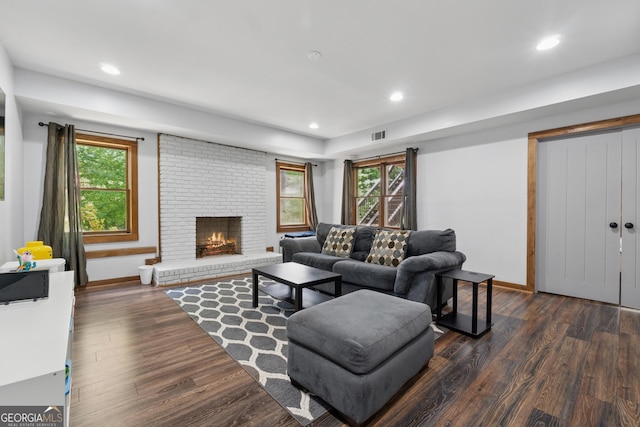 living room featuring plenty of natural light, wood finished floors, and a fireplace