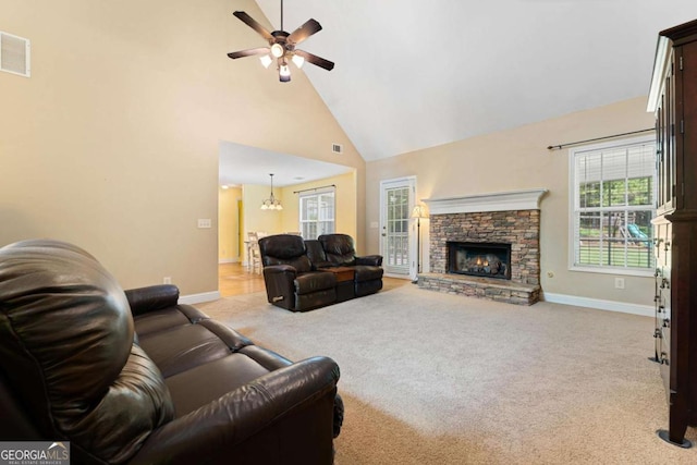 4572 Mulberry Fields Ln, Auburn, GA 30011 - carpeted living area featuring baseboards, plenty of natural light, ceiling fan with notable chandelier, and high vaulted ceiling