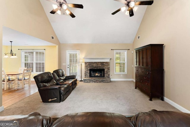 4572 Mulberry Fields Ln, Auburn, GA 30011 - carpeted living room with visible vents, a fireplace, baseboards, high vaulted ceiling, and a ceiling fan