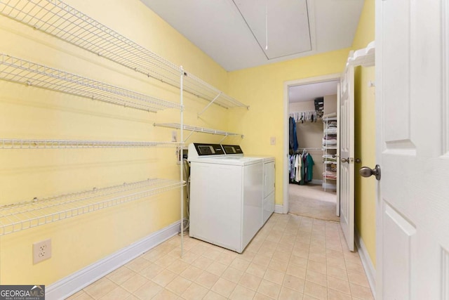 4572 Mulberry Fields Ln, Auburn, GA 30011 - clothes washing area with washing machine and clothes dryer, light tile patterned flooring, laundry area, and baseboards