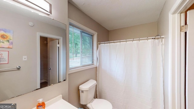 bathroom with toilet and curtained shower