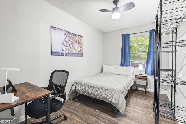 bedroom with baseboards and wood finished floors