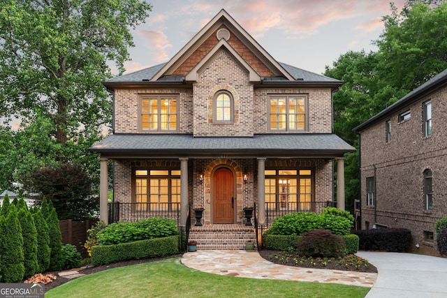 2017 Harts Mill Rd NE, Atlanta, GA 30341 - view of front of house with covered porch, brick siding, and a lawn