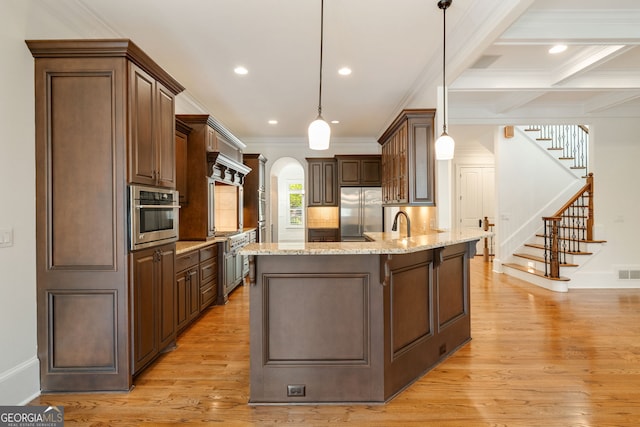 2017 Harts Mill Rd NE, Atlanta, GA 30341 - kitchen featuring appliances with stainless steel finishes, ornamental molding, light wood-type flooring, and arched walkways