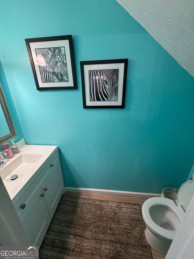 6444 Charter Way, Lithonia, GA 30058 - bathroom featuring baseboards, vanity, and toilet