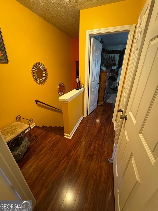 6444 Charter Way, Lithonia, GA 30058 - hallway featuring baseboards, dark wood-style flooring, and a textured ceiling