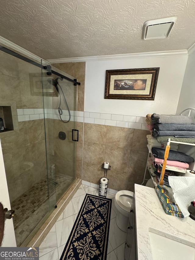 6444 Charter Way, Lithonia, GA 30058 - full bathroom featuring crown molding, toilet, a textured ceiling, tile walls, and a shower stall