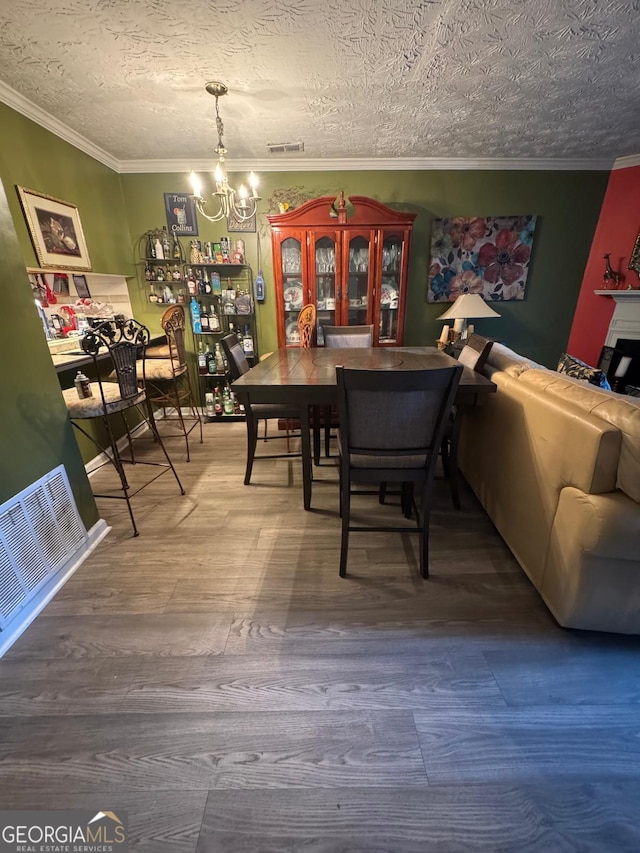 6444 Charter Way, Lithonia, GA 30058 - dining room featuring visible vents, ornamental molding, wood finished floors, and a chandelier