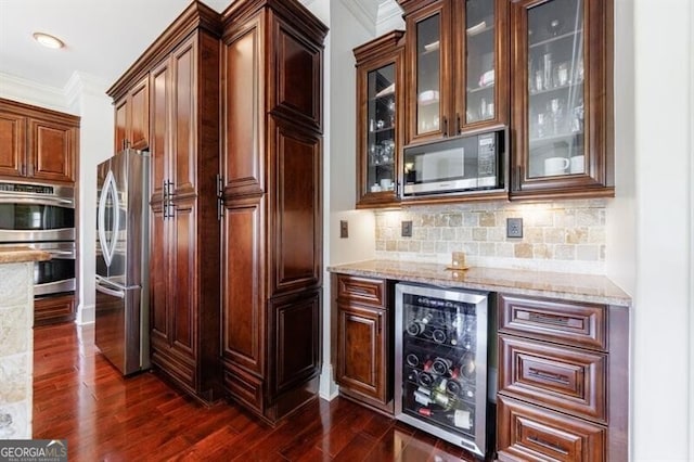 bar featuring dark wood-style flooring, beverage cooler, stainless steel appliances, tasteful backsplash, and ornamental molding