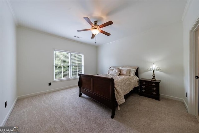 carpeted bedroom featuring visible vents, a ceiling fan, baseboards, and crown molding