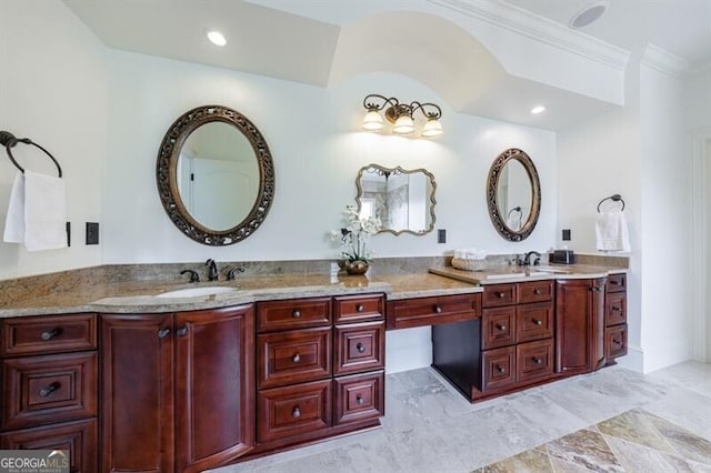bathroom featuring a sink, ornamental molding, and double vanity