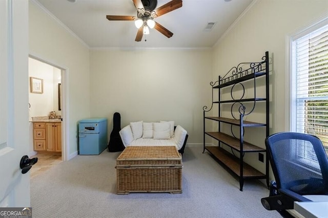 living area with ornamental molding, light carpet, a ceiling fan, and visible vents