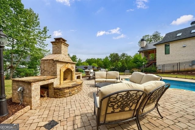 view of patio with fence, an outdoor living space with a fireplace, and a fenced in pool
