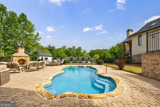 view of pool featuring a fenced in pool, a patio area, fence, and an outdoor living space with a fireplace