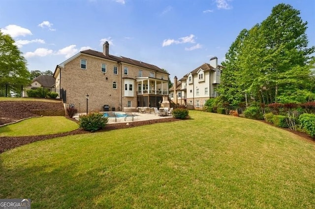 back of house featuring a patio, a lawn, fence, and an outdoor pool