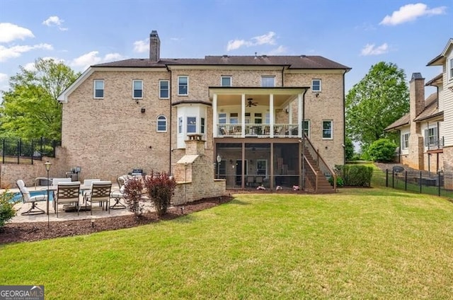 rear view of house with a ceiling fan, a lawn, stairway, fence, and a patio