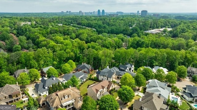 birds eye view of property with a residential view and a view of trees