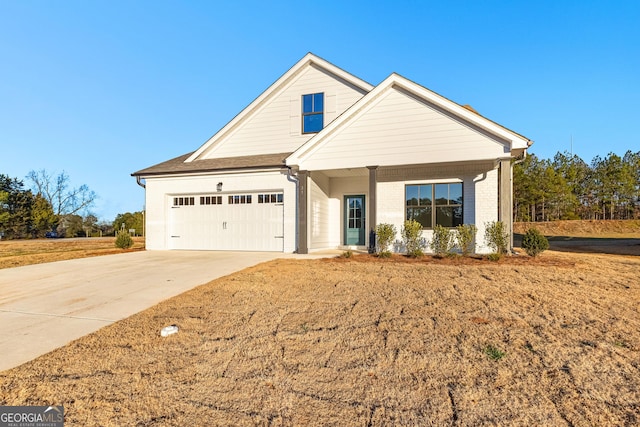 view of front facade featuring brick siding, a garage, a porch, and concrete driveway