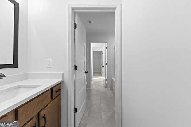 bathroom with vanity, marble finish floor, baseboards, and visible vents