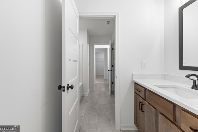bathroom with vanity, tile patterned flooring, baseboards, and visible vents