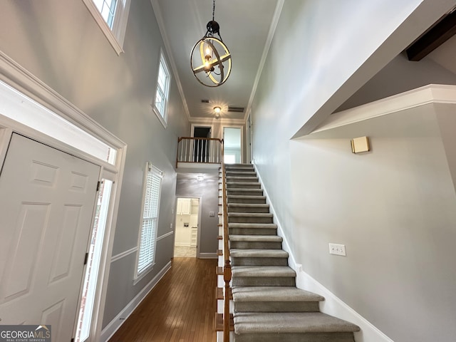 23 Saint Ives Ln, Winder, GA 30680 - entrance foyer featuring crown molding, plenty of natural light, stairway, and a towering ceiling