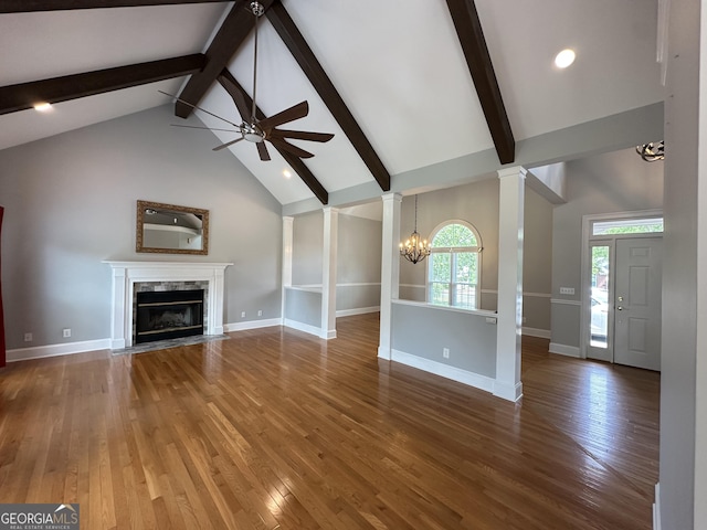 23 Saint Ives Ln, Winder, GA 30680 - unfurnished living room with decorative columns, beam ceiling, high vaulted ceiling, ceiling fan with notable chandelier, and a premium fireplace