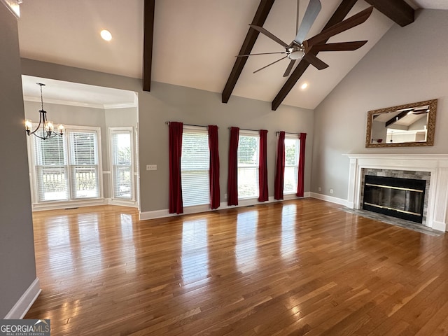 23 Saint Ives Ln, Winder, GA 30680 - unfurnished living room featuring plenty of natural light, ceiling fan with notable chandelier, beam ceiling, and wood finished floors